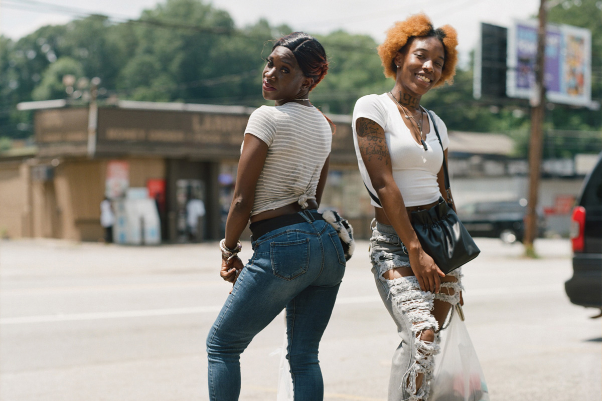 Two women posing in a parking lot on Headland Dr.