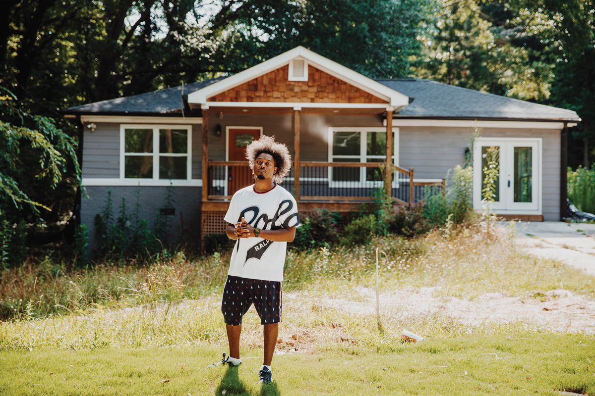 Quincey Patterson standing in front of his childhood home on South Eugenia Place